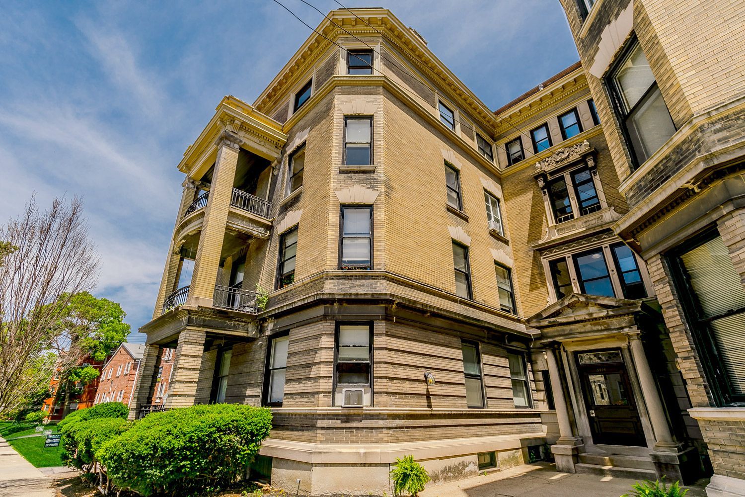 A large brick building with a lot of windows on a sunny day.