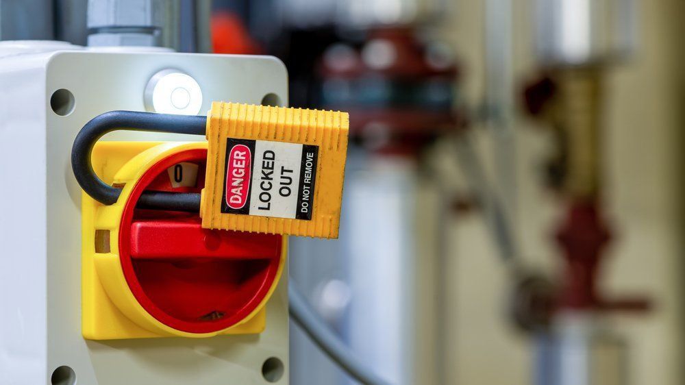 A Yellow And Red Electrical Switch With A Locked Out Tag Attached To  It — NFL Electrical In Stoney Creek, QLD