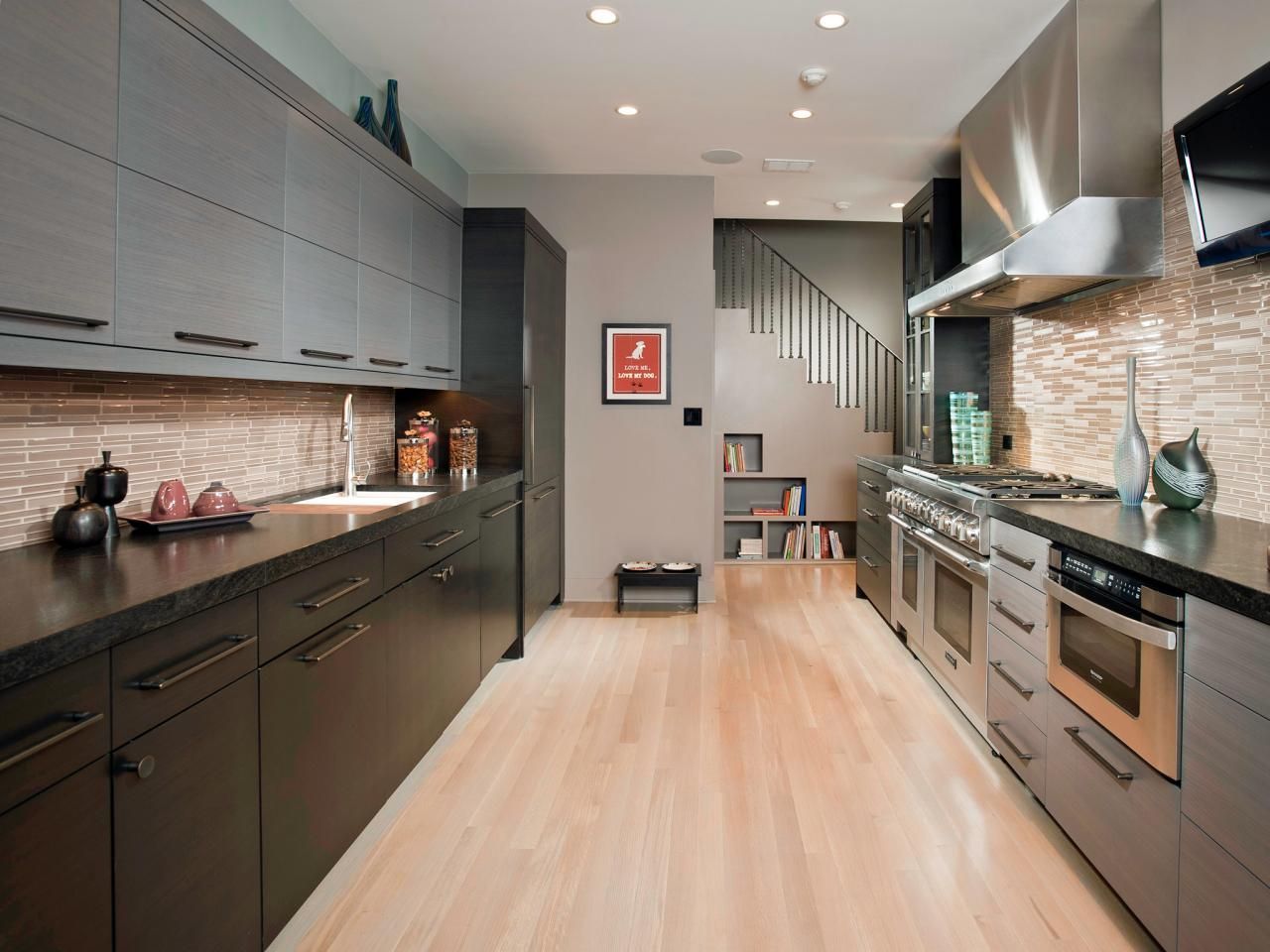 A kitchen with stainless steel appliances and black cabinets