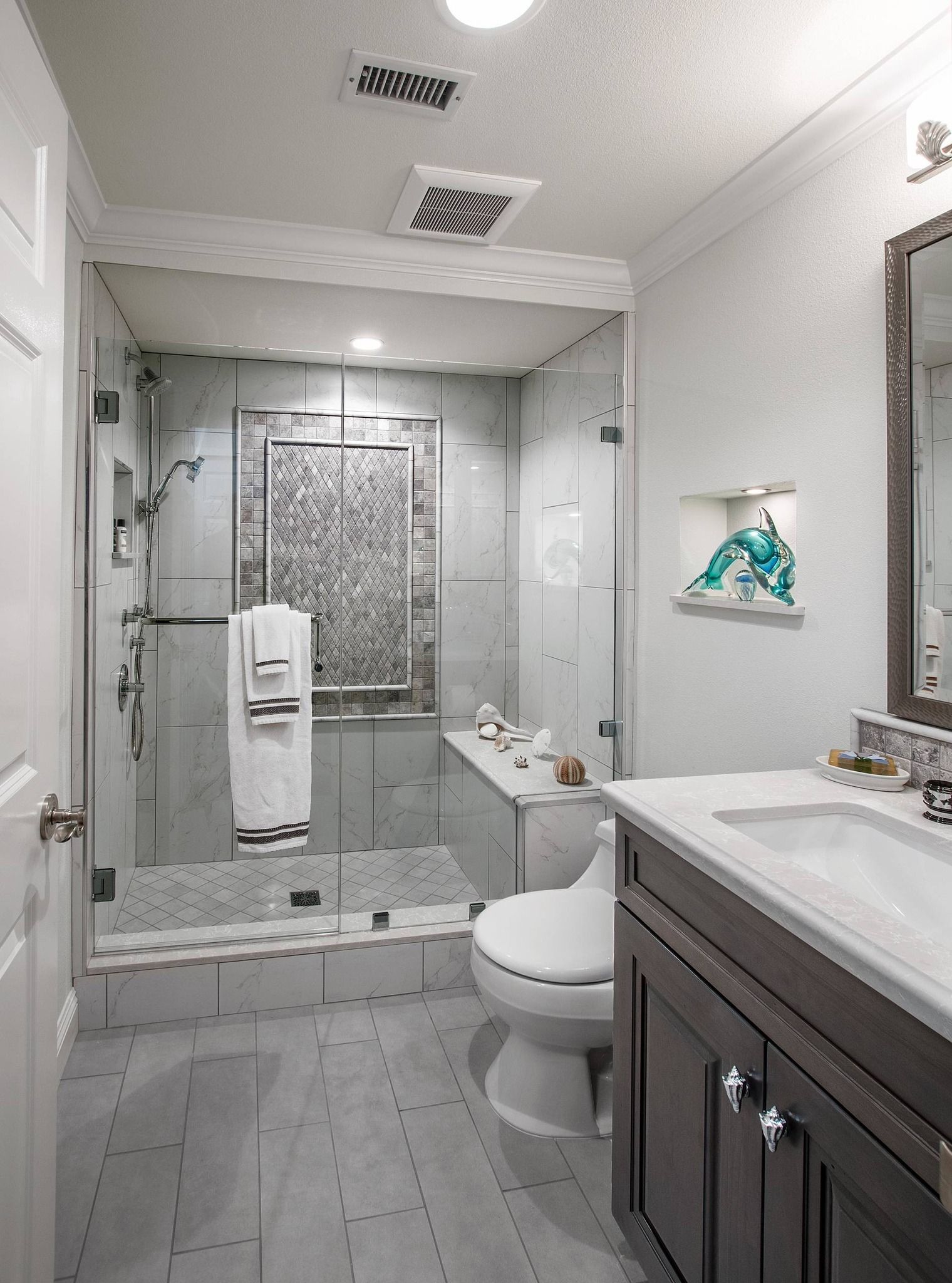 A bathroom with a toilet a sink and a shower