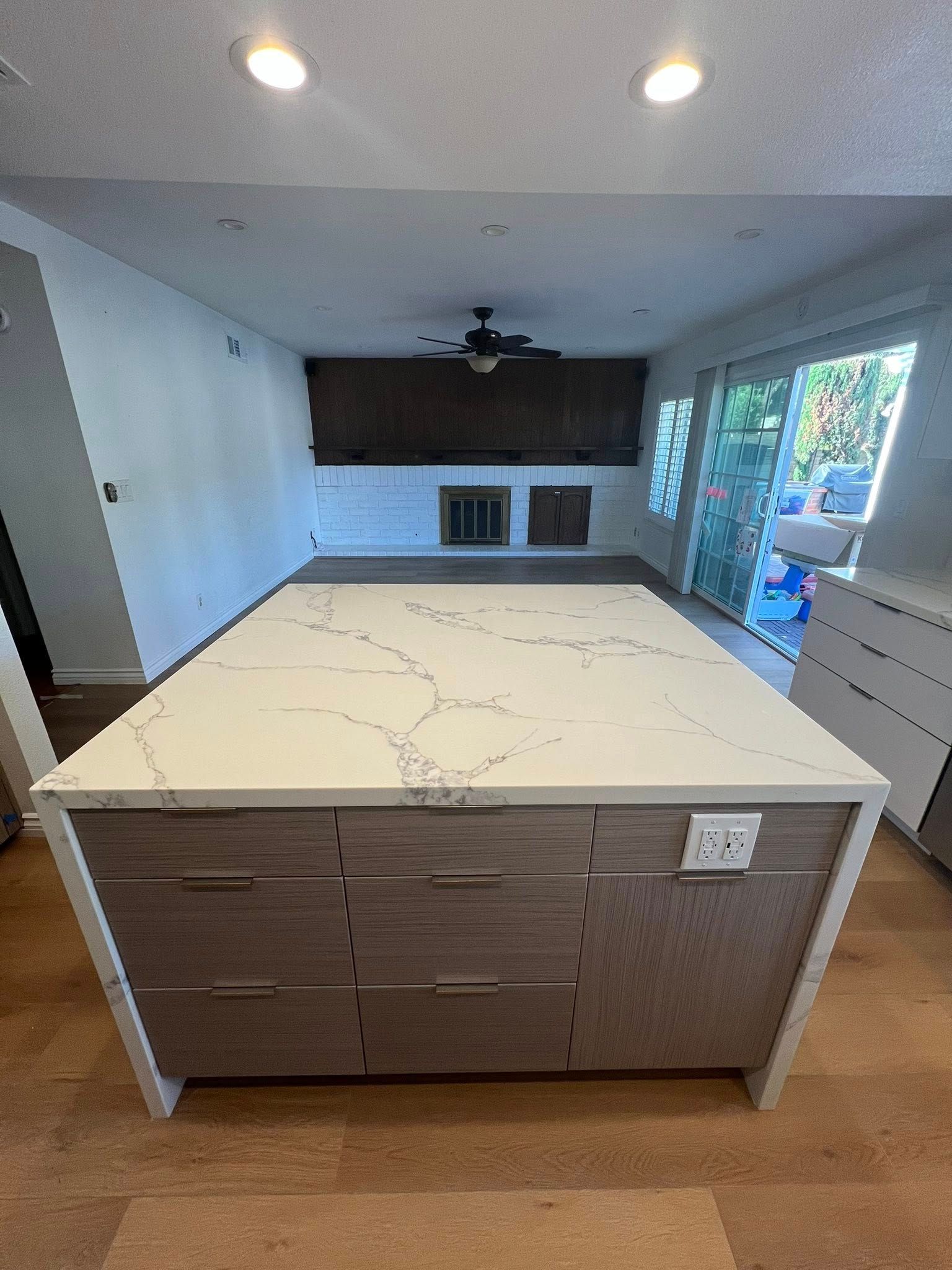 A kitchen with a large island in the middle of the room.