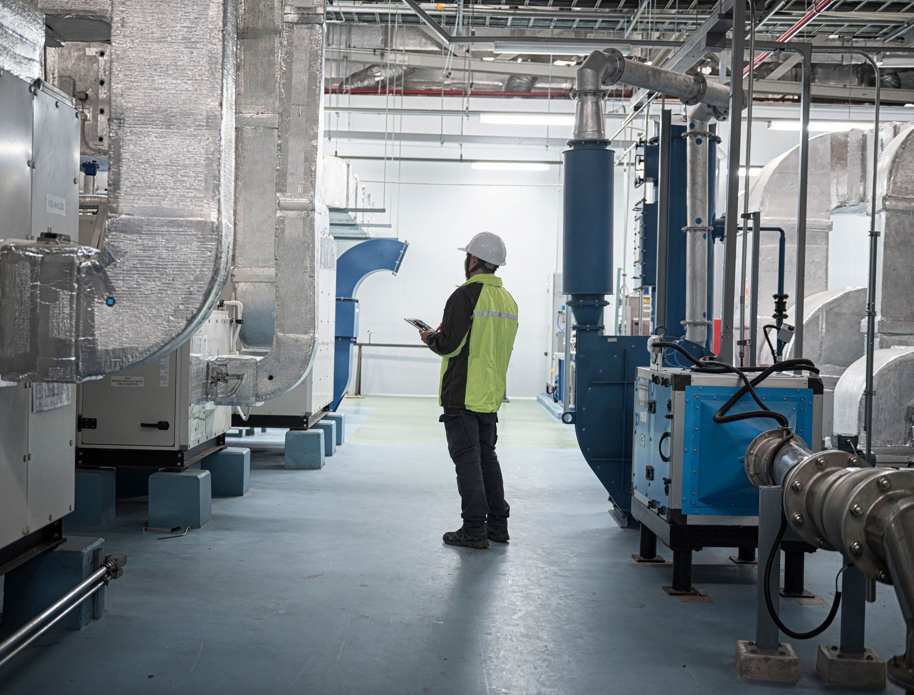 Engineer performing pipe system inspection.