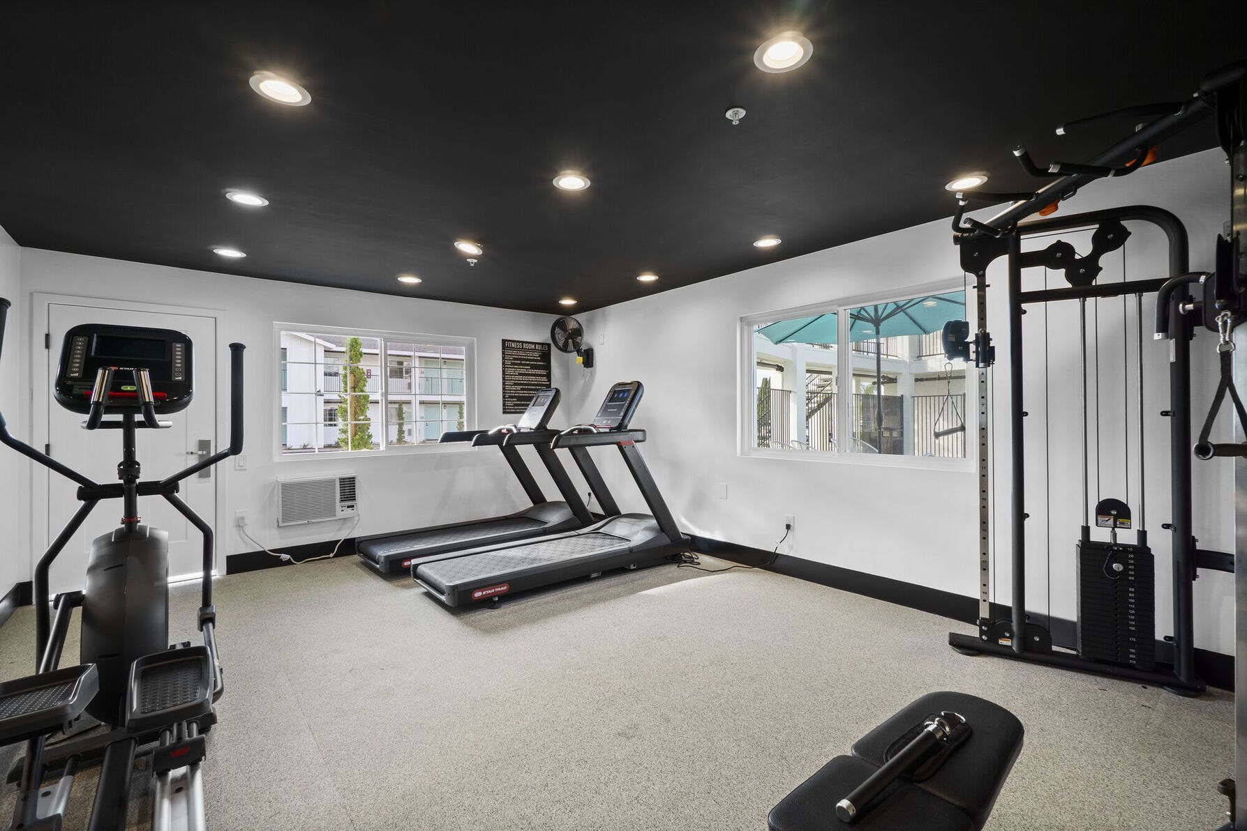 alternate photo of the gym, showing the pool area outside