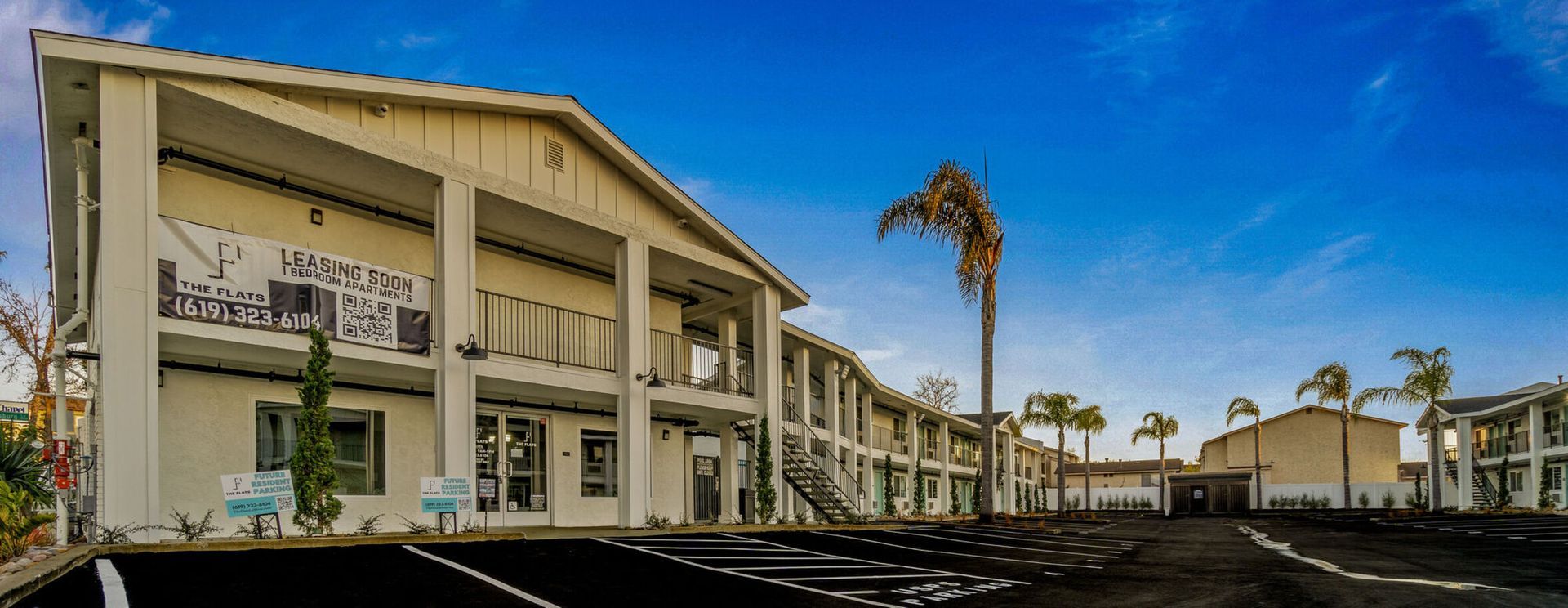 Photo showing a building, seen from the parking lot. The building is two stories tall