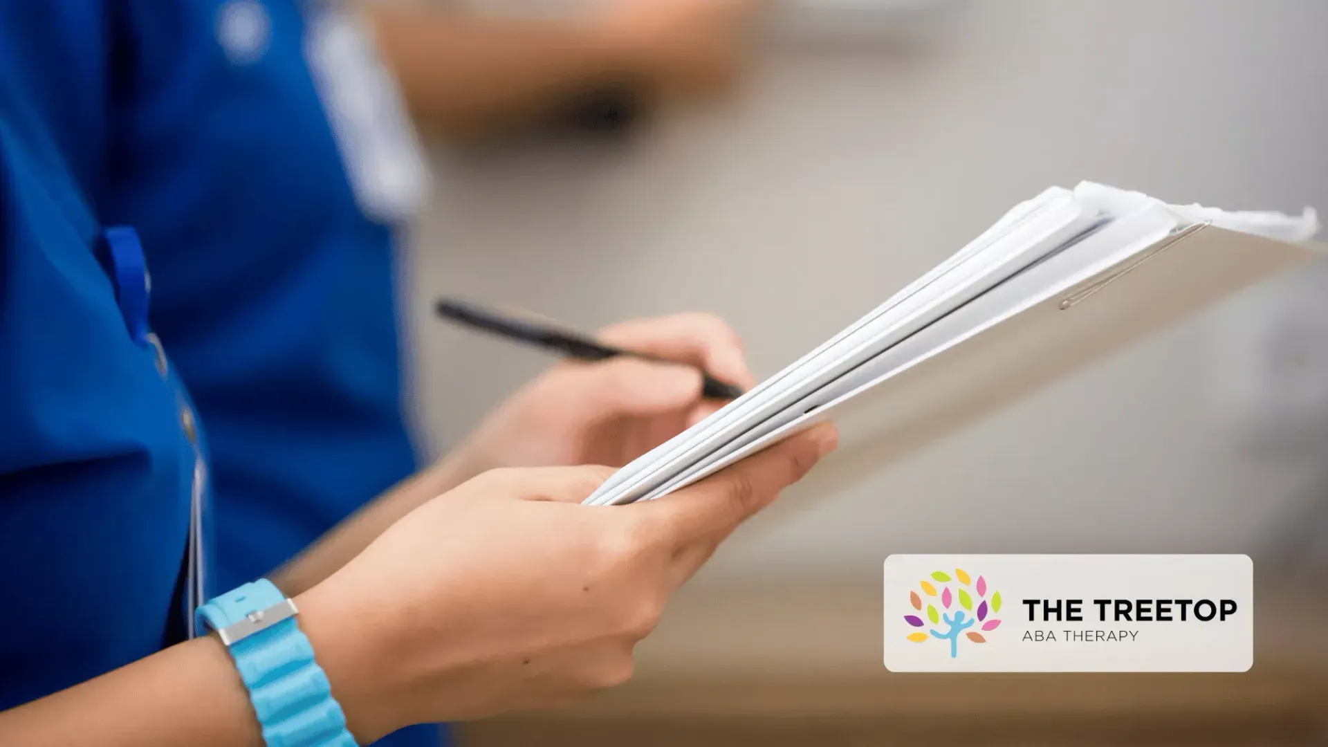 A person in a blue uniform writes on a notepad with a pen, with a Treetop logo in the corner.
