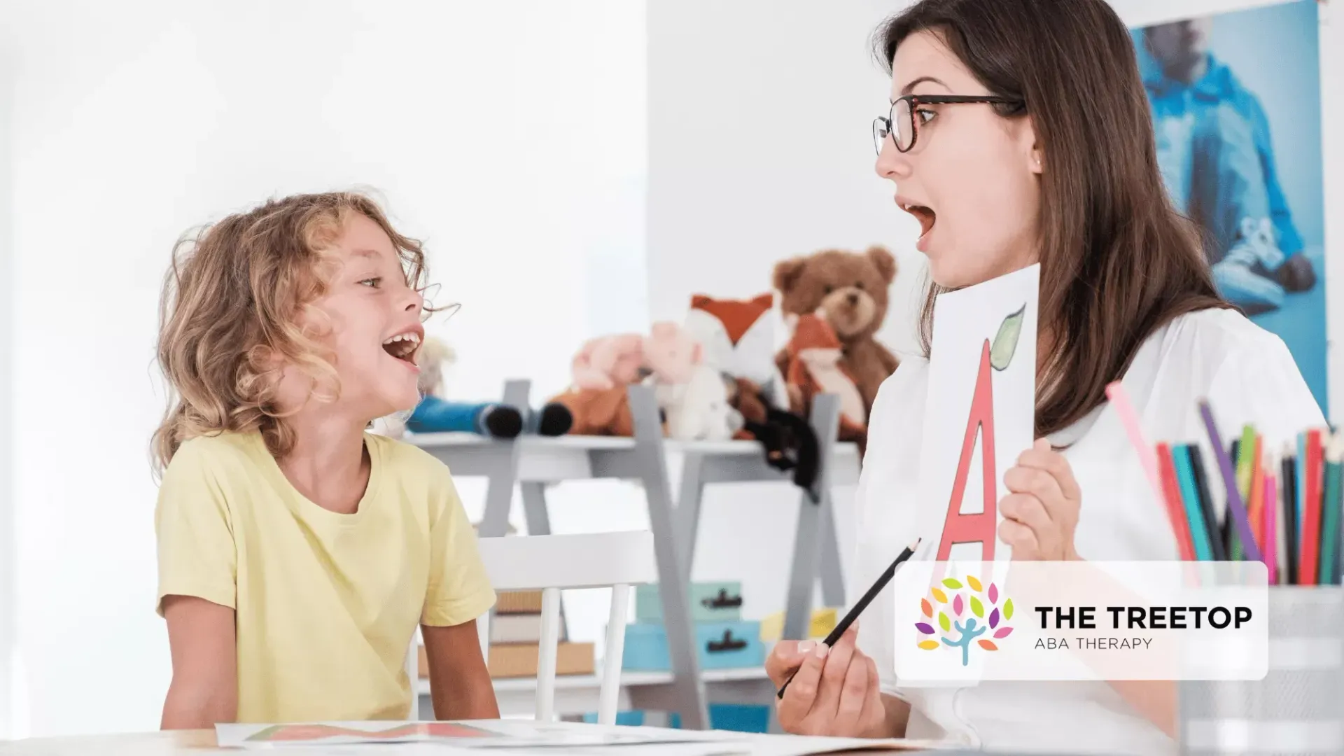 A therapist showing a flashcard with the letter 