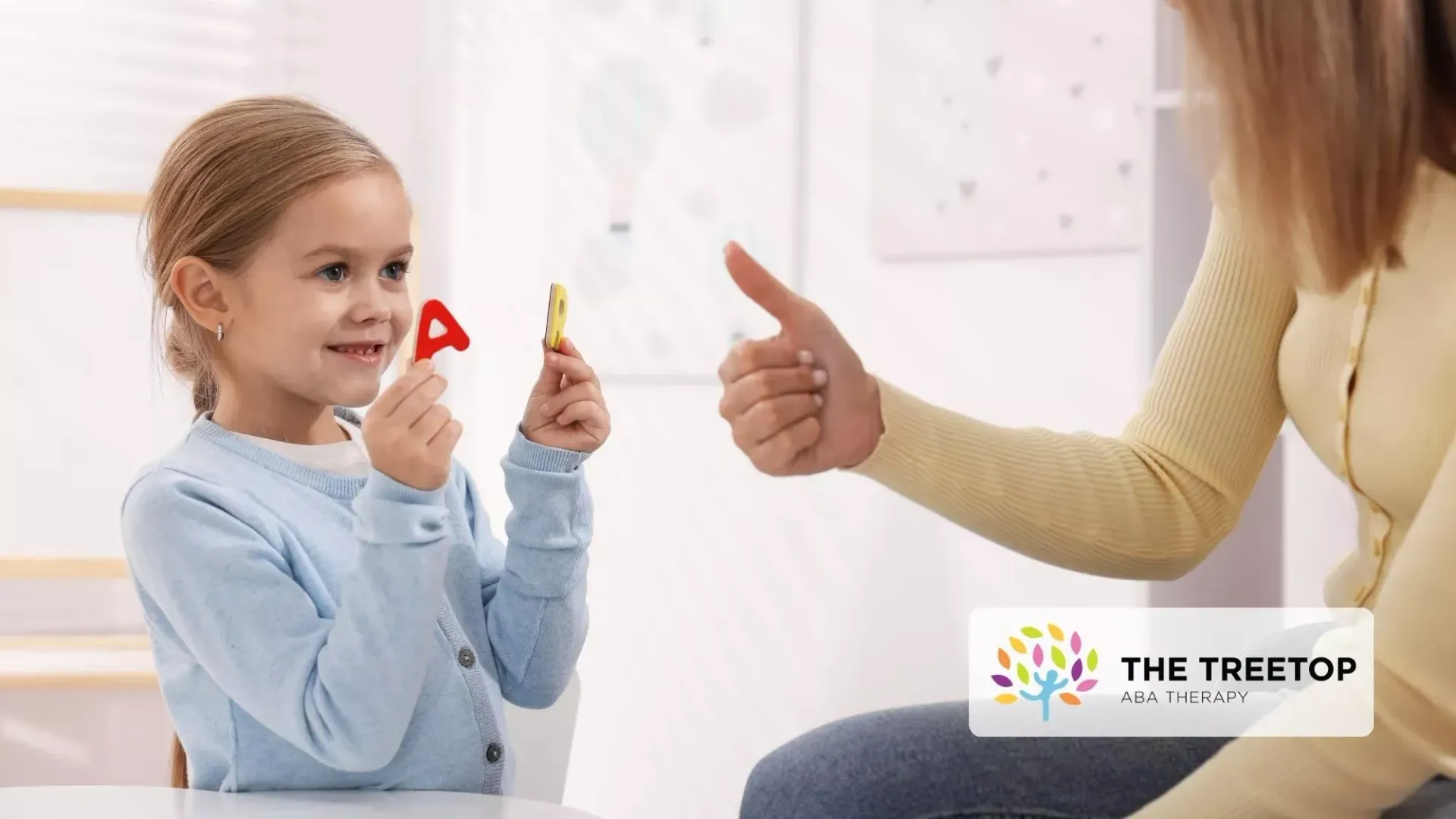Woman and young child sharing a thumbs-up during a game in a bright room