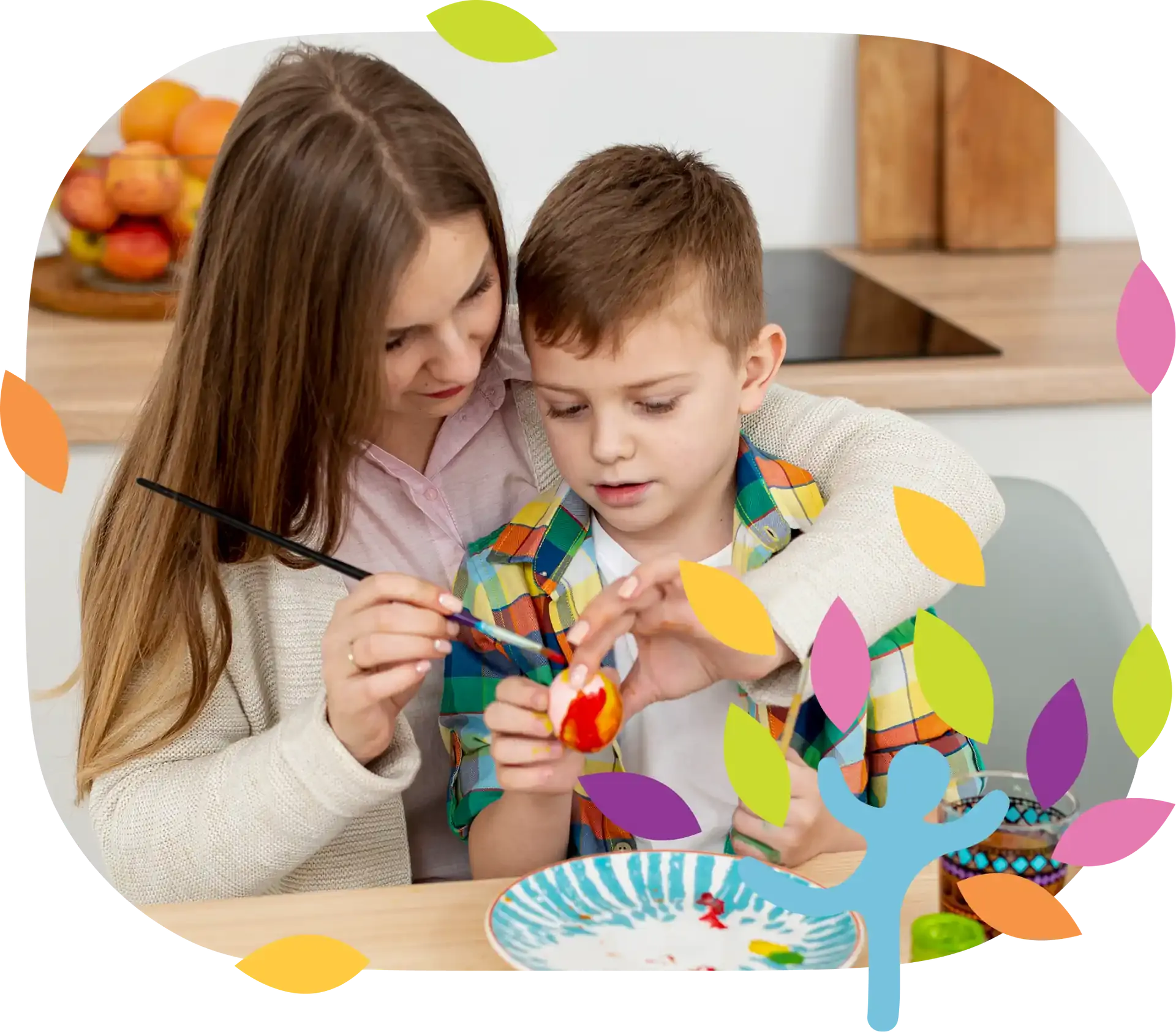A person helps a child paint a small egg at a wooden table in a kitchen.