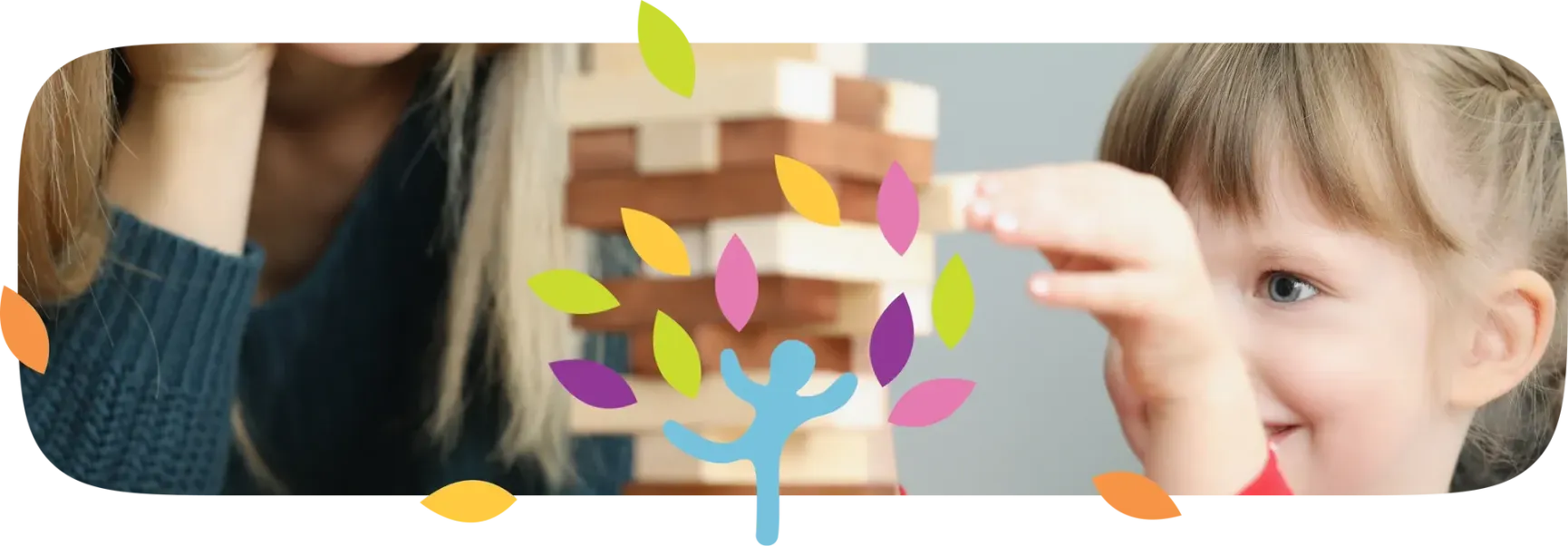 A child focuses on removing a wooden block from a Jenga tower, with a person sitting nearby and a colorful leaf icon.