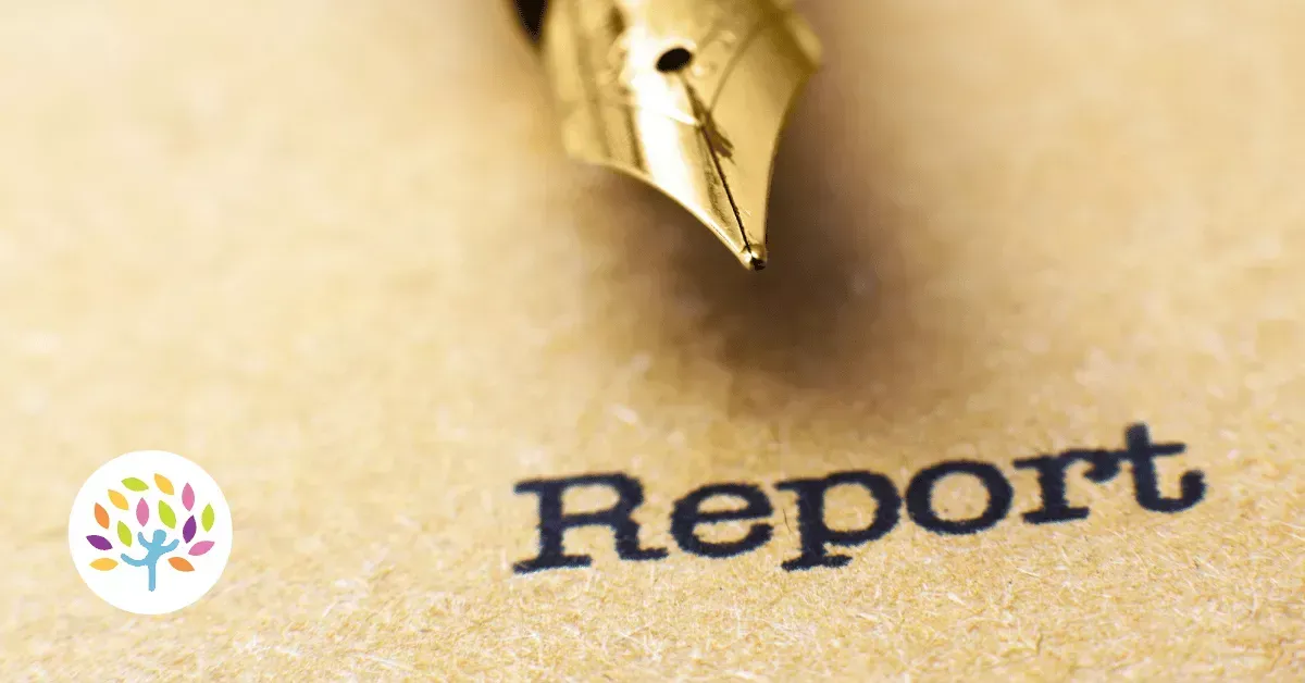 A gold fountain pen tip rests on textured paper above the word