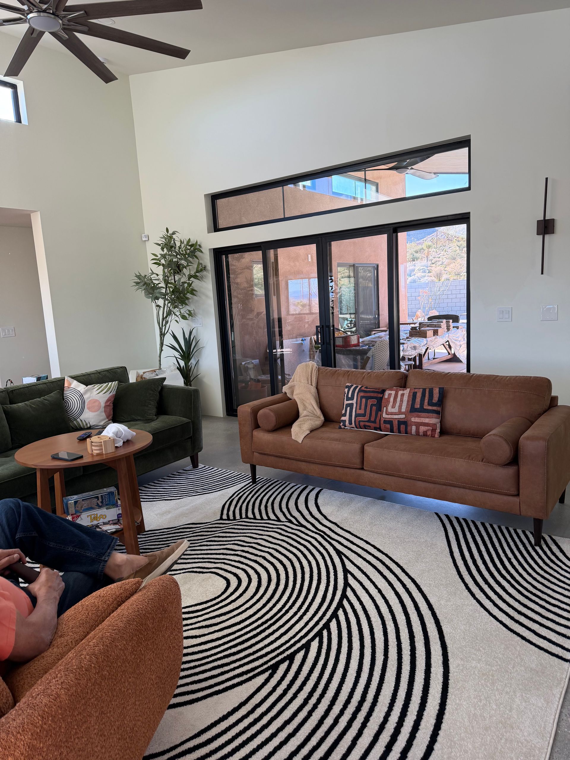 Living room with two sofas, a round rug, and sliding glass doors to a patio.