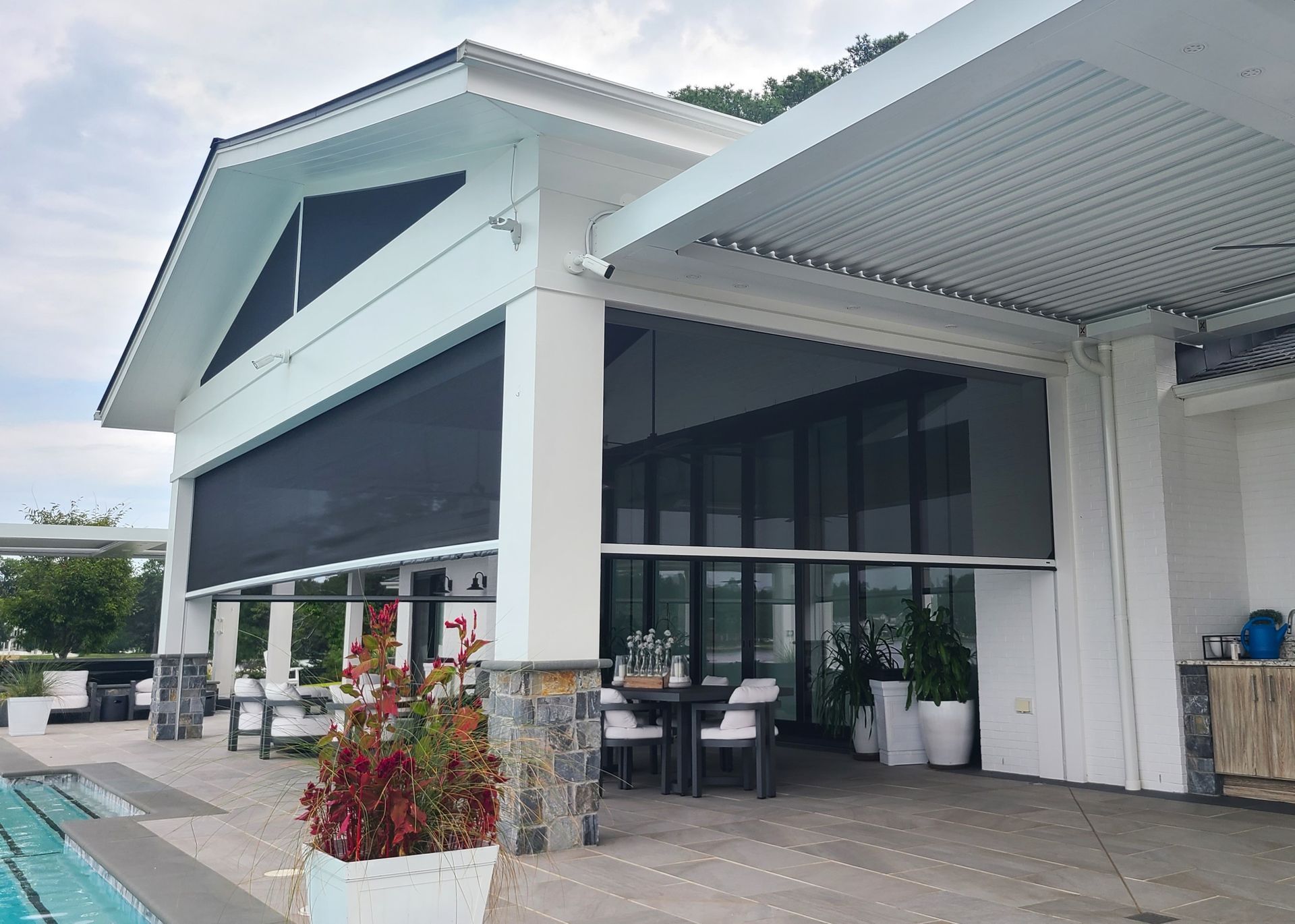 A large white building with a swimming pool in front of it.