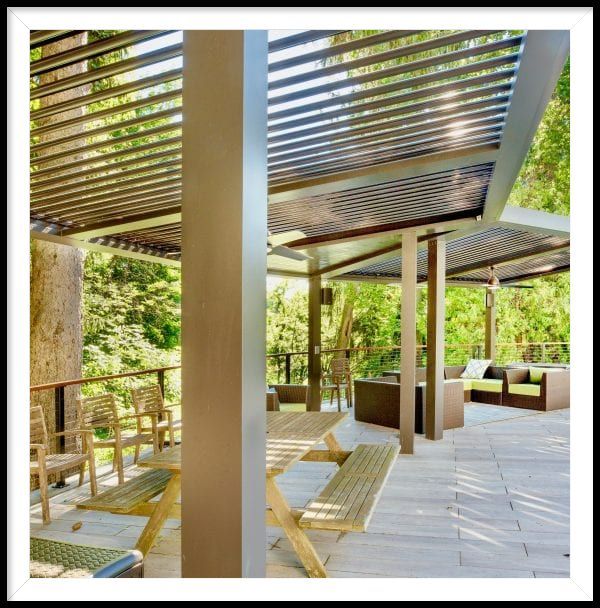 A patio with a pergola and a picnic table