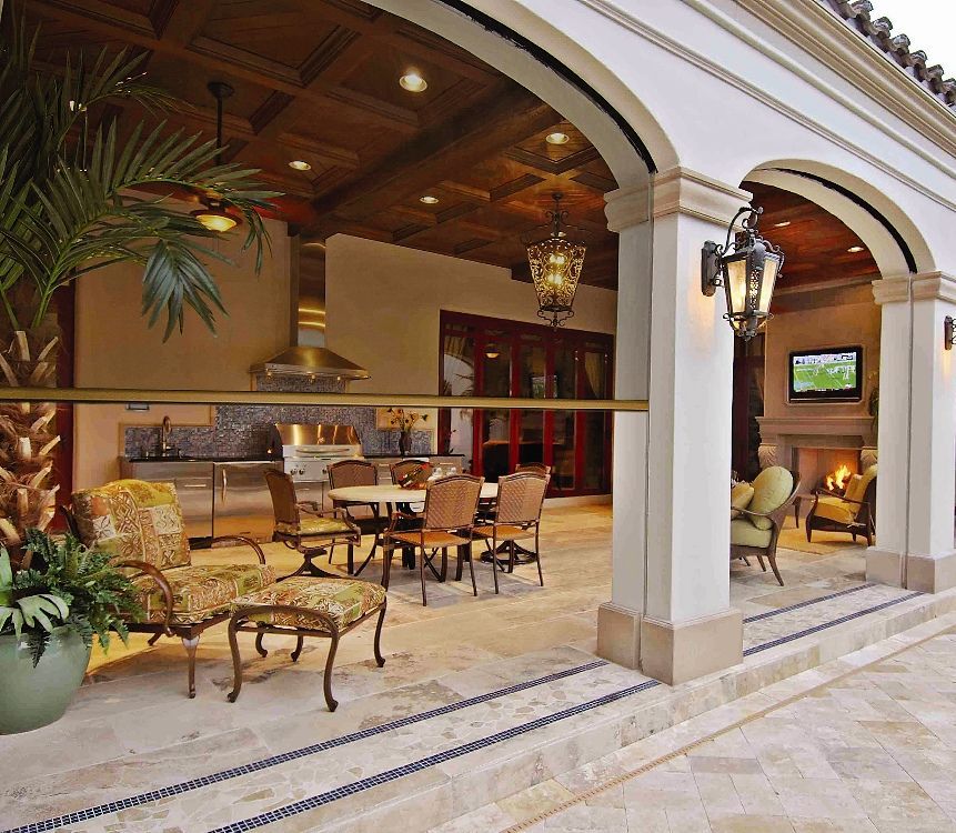 A patio with tables and chairs and a television
