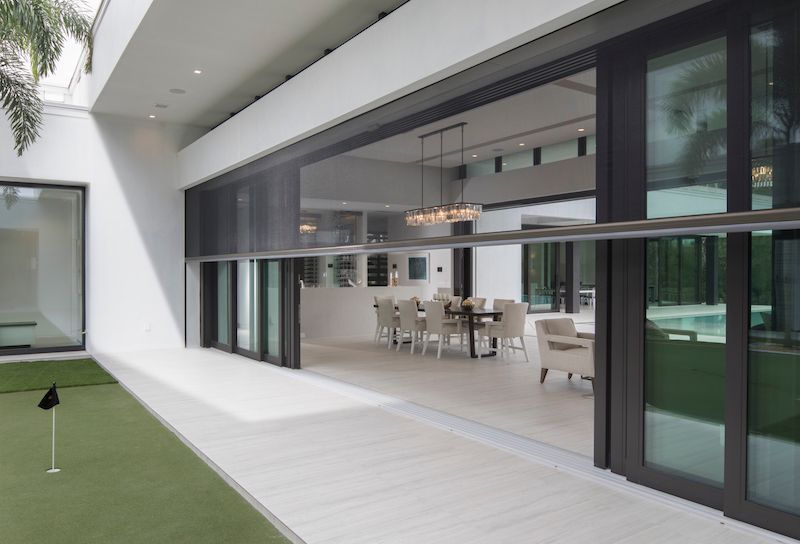 A large house with a lot of windows and a dining room