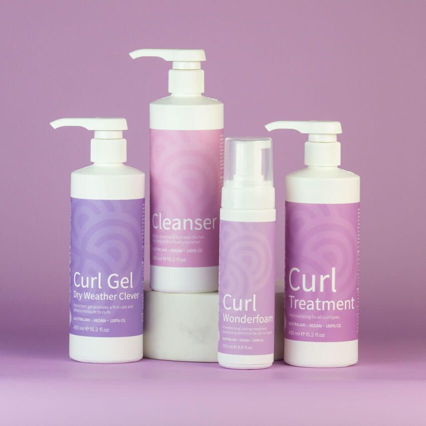 Four Bottles of Curl Products Are Stacked on Top of Each Other — Statix Hair Yeppoon in Blackwater, QLD