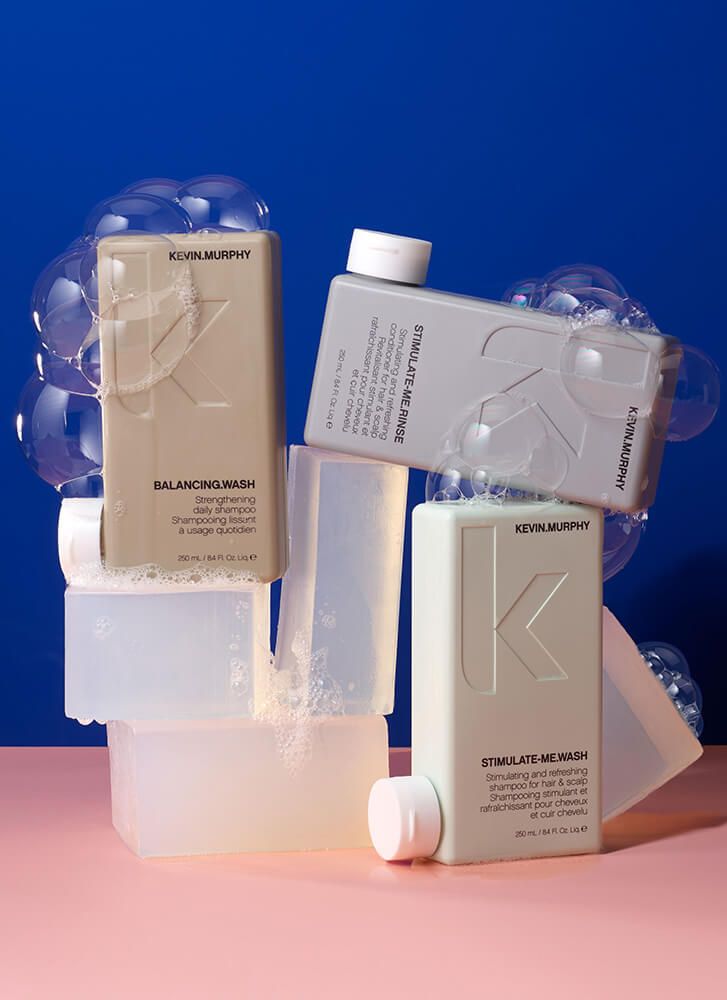 Three Bottles of Shampoo Are Stacked on Top of Each Other on A Pink Table — Statix Hair Yeppoon in Rockhampton City, QLD