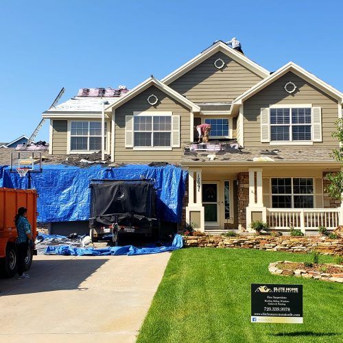 A large house with a truck parked in front of it