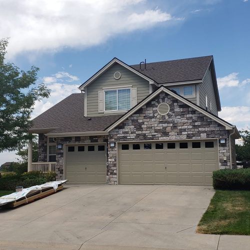 A large house with a truck parked in front of it