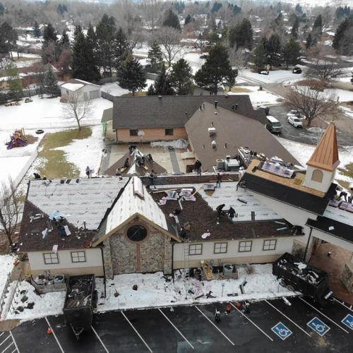 An aerial view of a church under construction in the snow