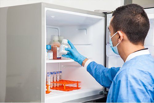 Medical Refrigeration Repair — Doctor Getting Plastic Bottle In Refrigerator in Gresham, OR