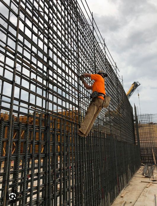 Palma Construction LLC | A pile of stainless steel bars stacked on top of each other on a table.