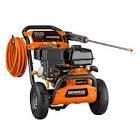 A gas powered pressure washer with a hose attached to it.