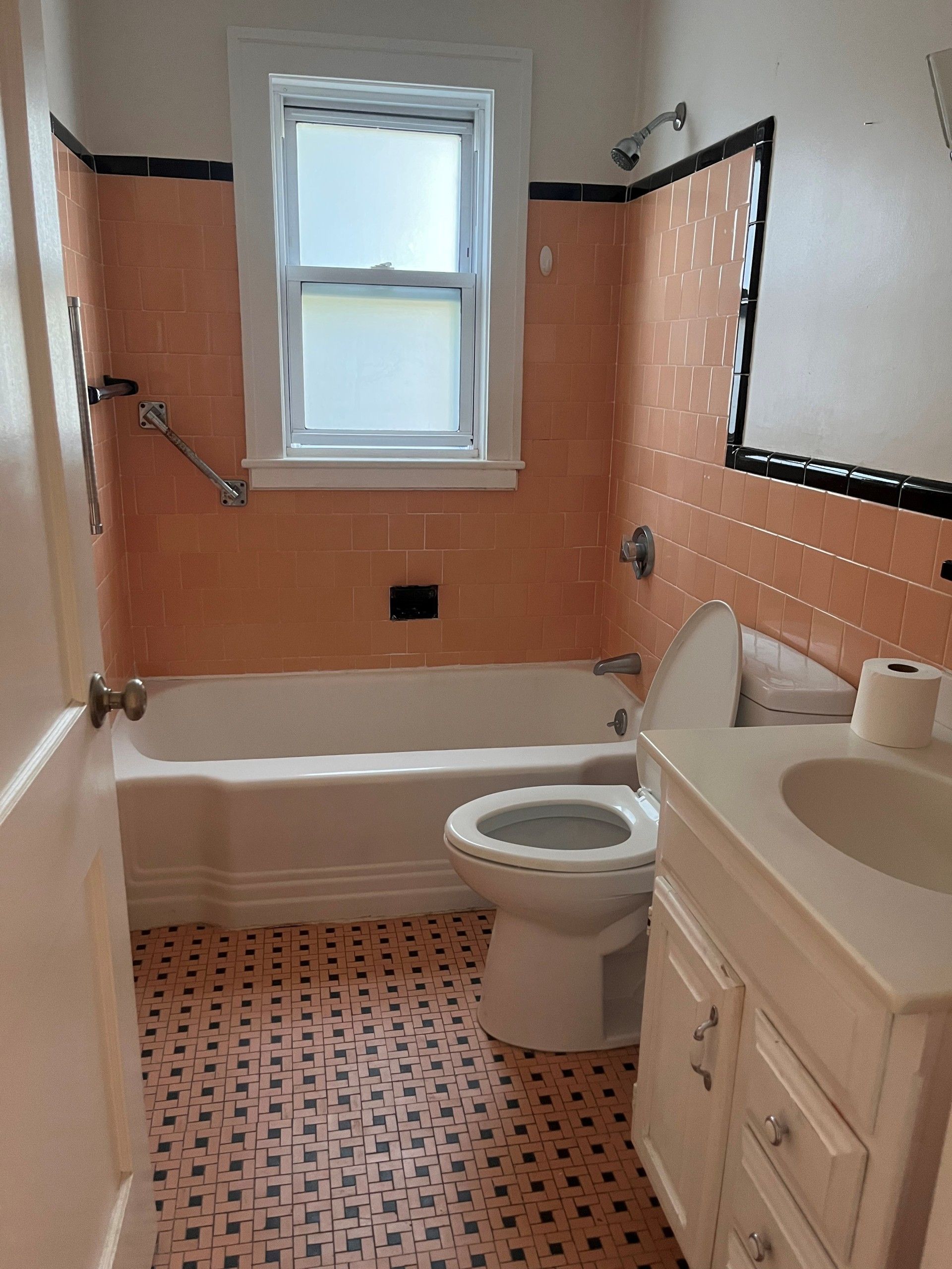 A bathroom with a toilet a sink and a bathtub