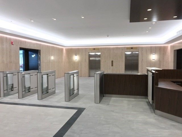 An empty lobby with elevators and a counter
