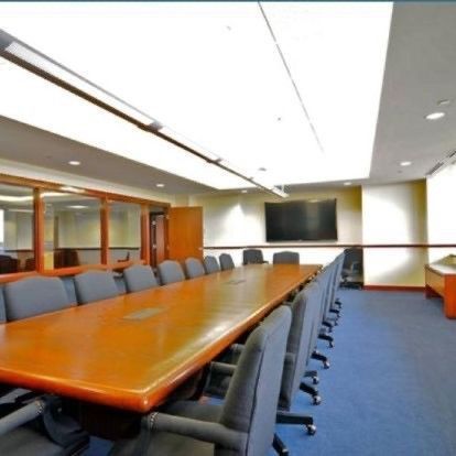 A conference room with a long table and chairs