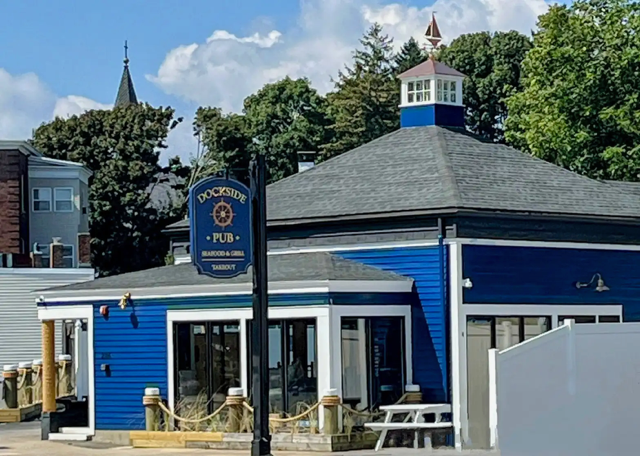 A blue building with a sign in front of it that says coopers pub