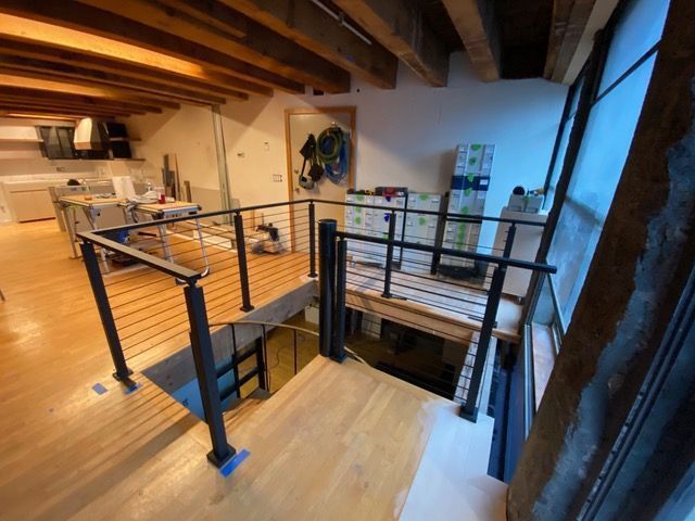 A room with a wooden floor and a metal railing.