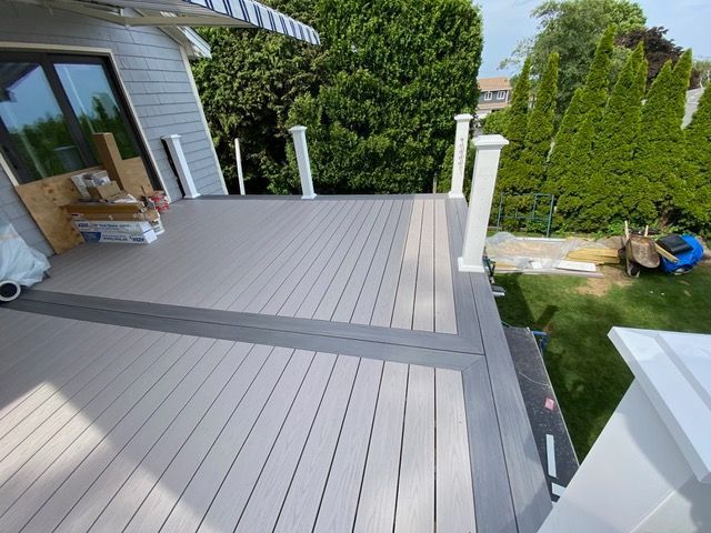 A wooden deck with a white awning on top of it