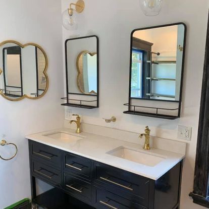 A bathroom with two sinks and two mirrors.