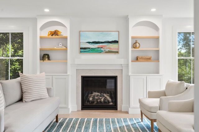 There is a fireplace in the middle of the living room.