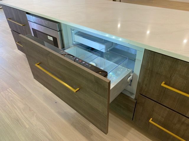 A kitchen with a refrigerator drawer open