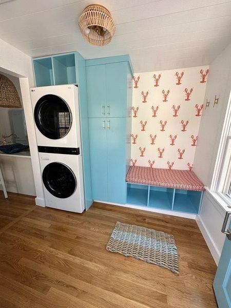 A laundry room with a washer and dryer stacked on top of each other.