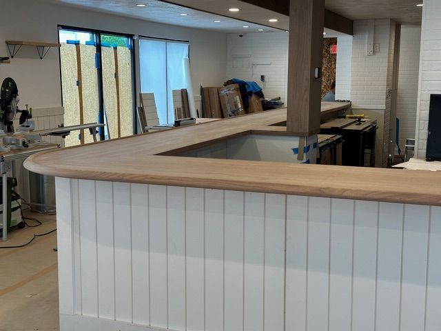 A wooden counter top is being built in a kitchen.