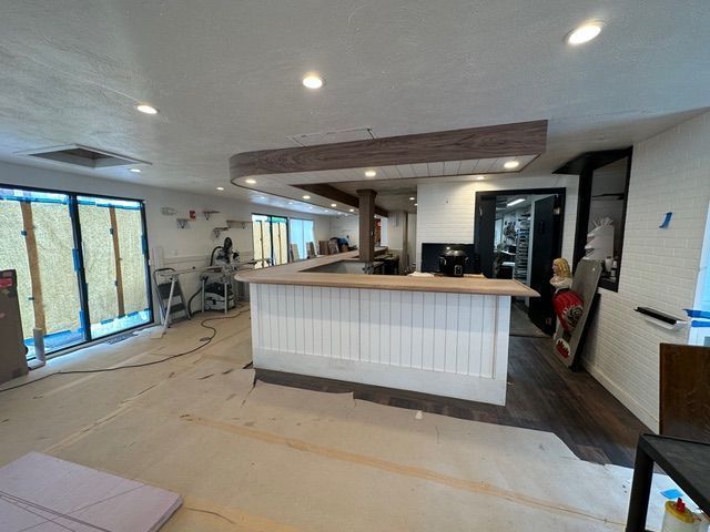 A large room with a counter in the middle of it