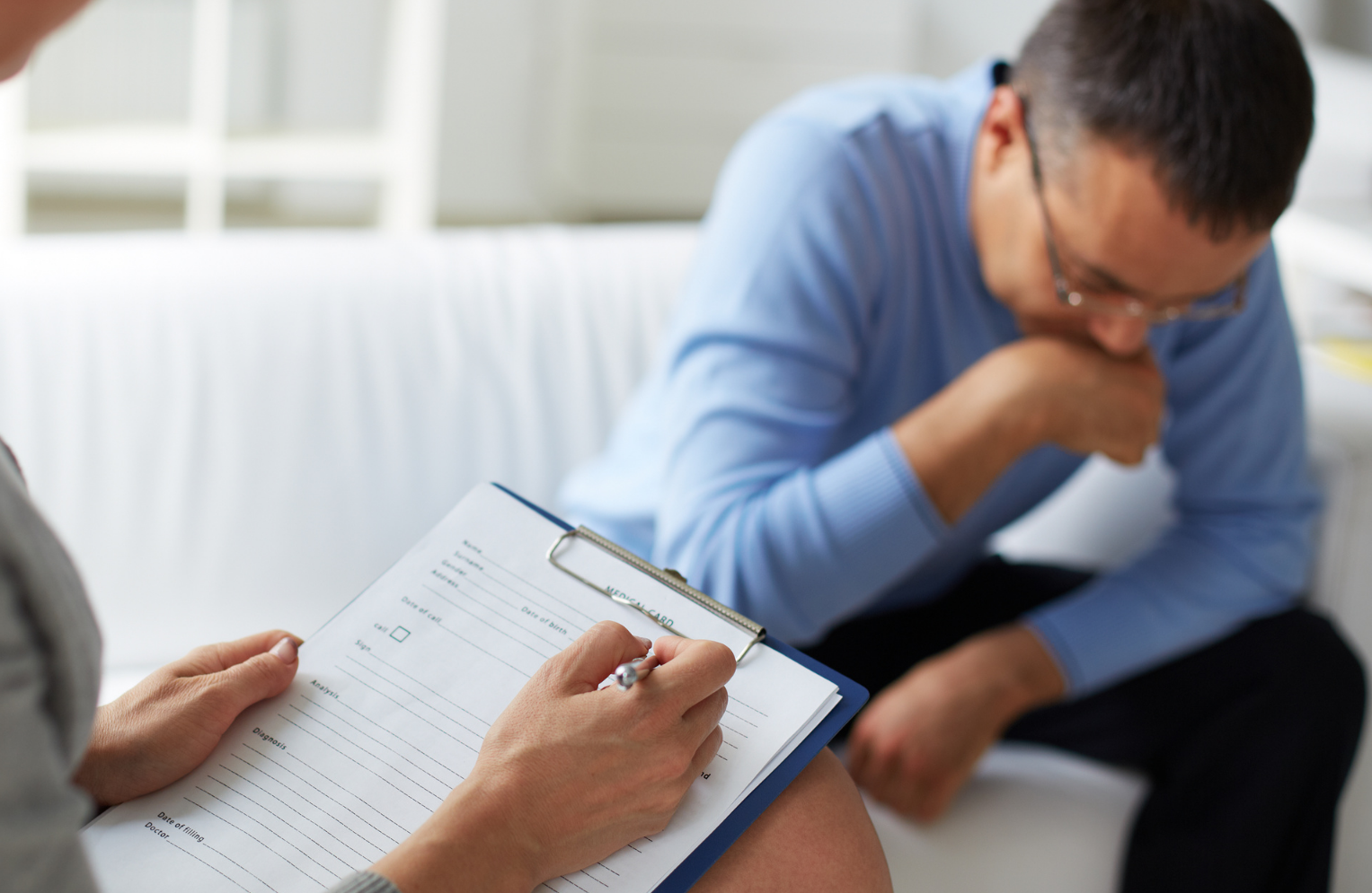 A female doctor is smiling while talking to a patient