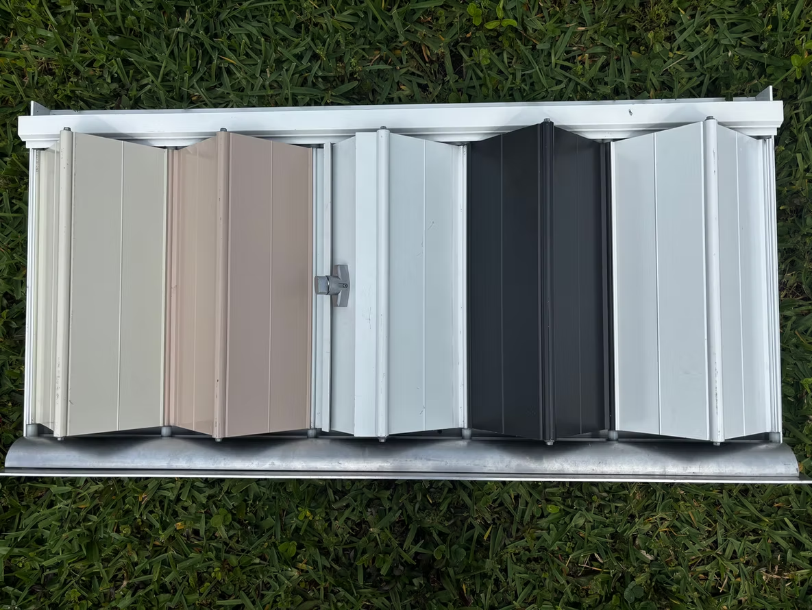 A close up of a black roller blind on a window.