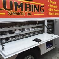 A white service truck labeled 