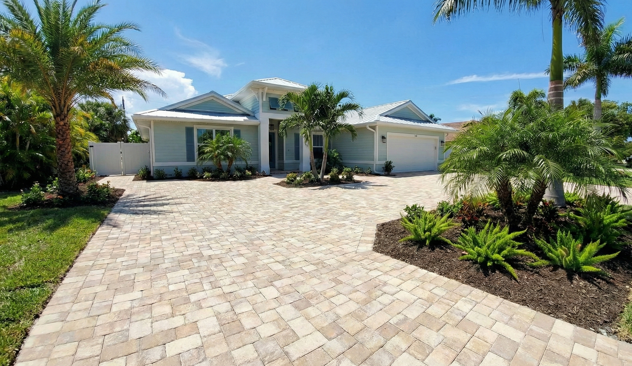 Stone staircase with decorative brick border ascends through a landscaped yard.