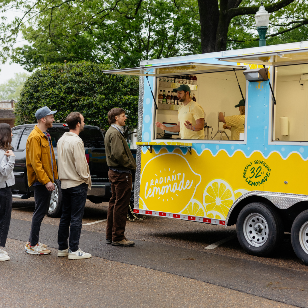 Two people holding lemonade that is splashing.