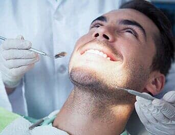 Man having a tooth check up — Oral Hygiene in Naples, FL