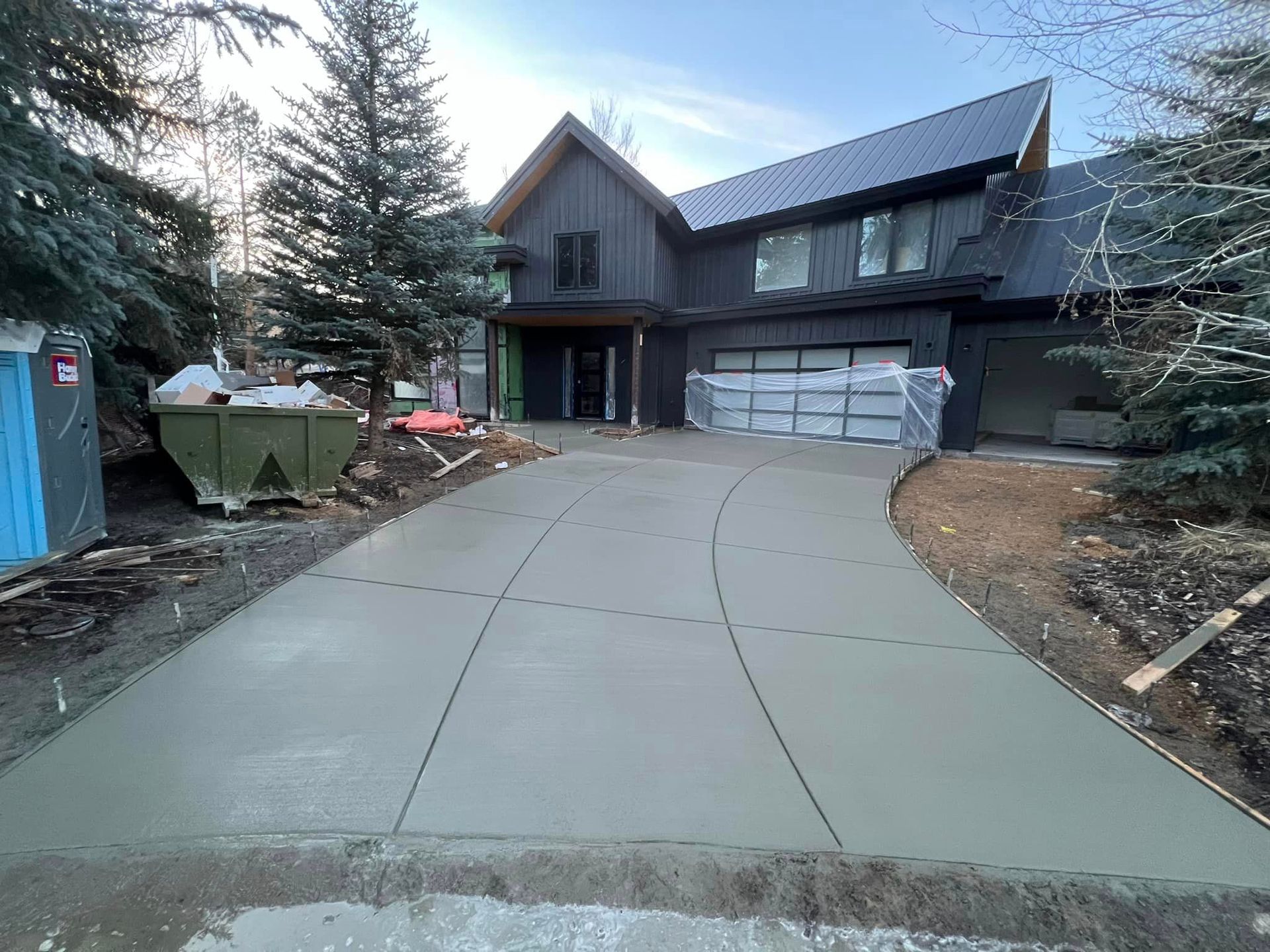 A large house with a concrete driveway in front of it.