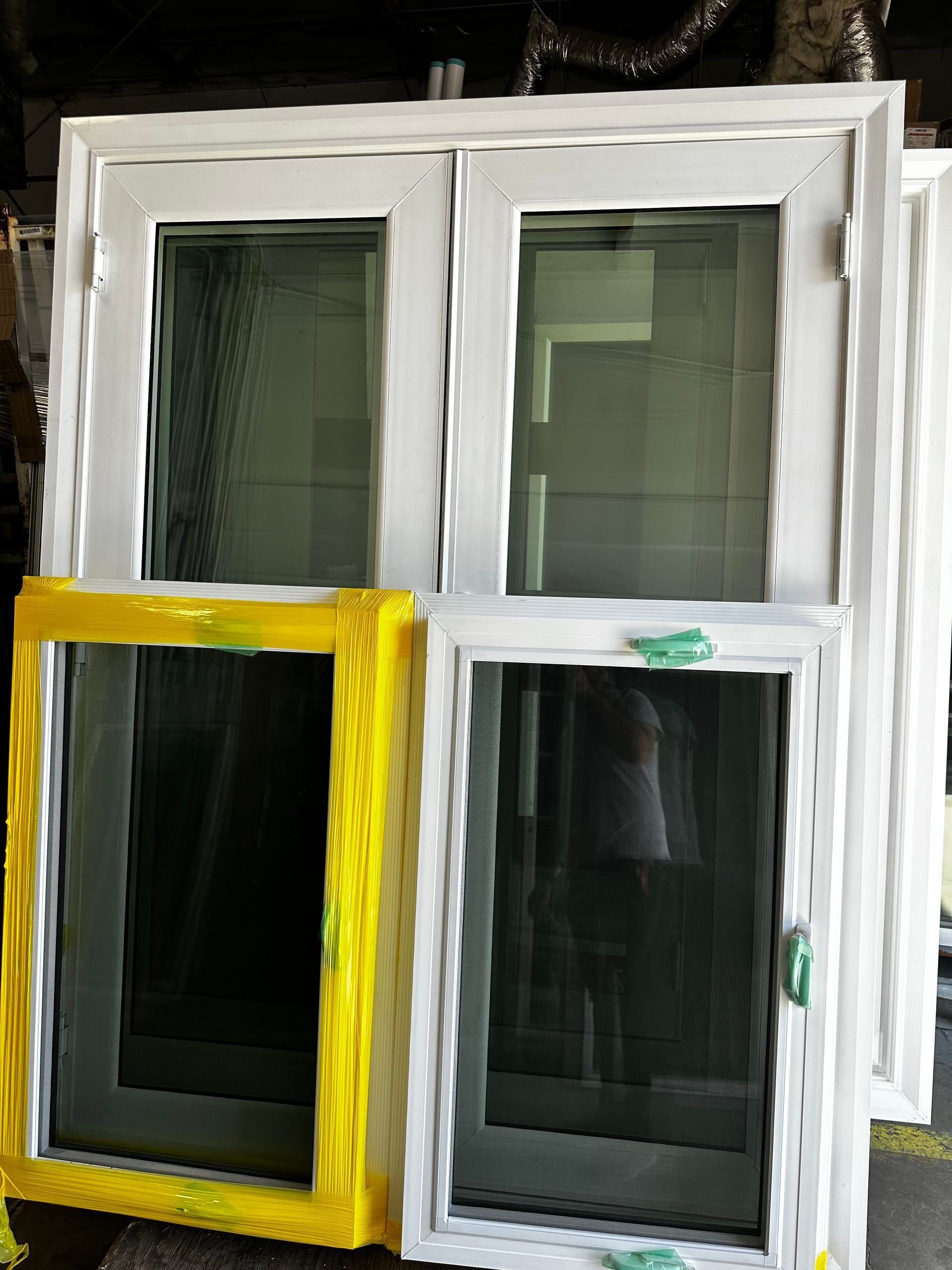 A white window with a yellow frame is sitting on a table.