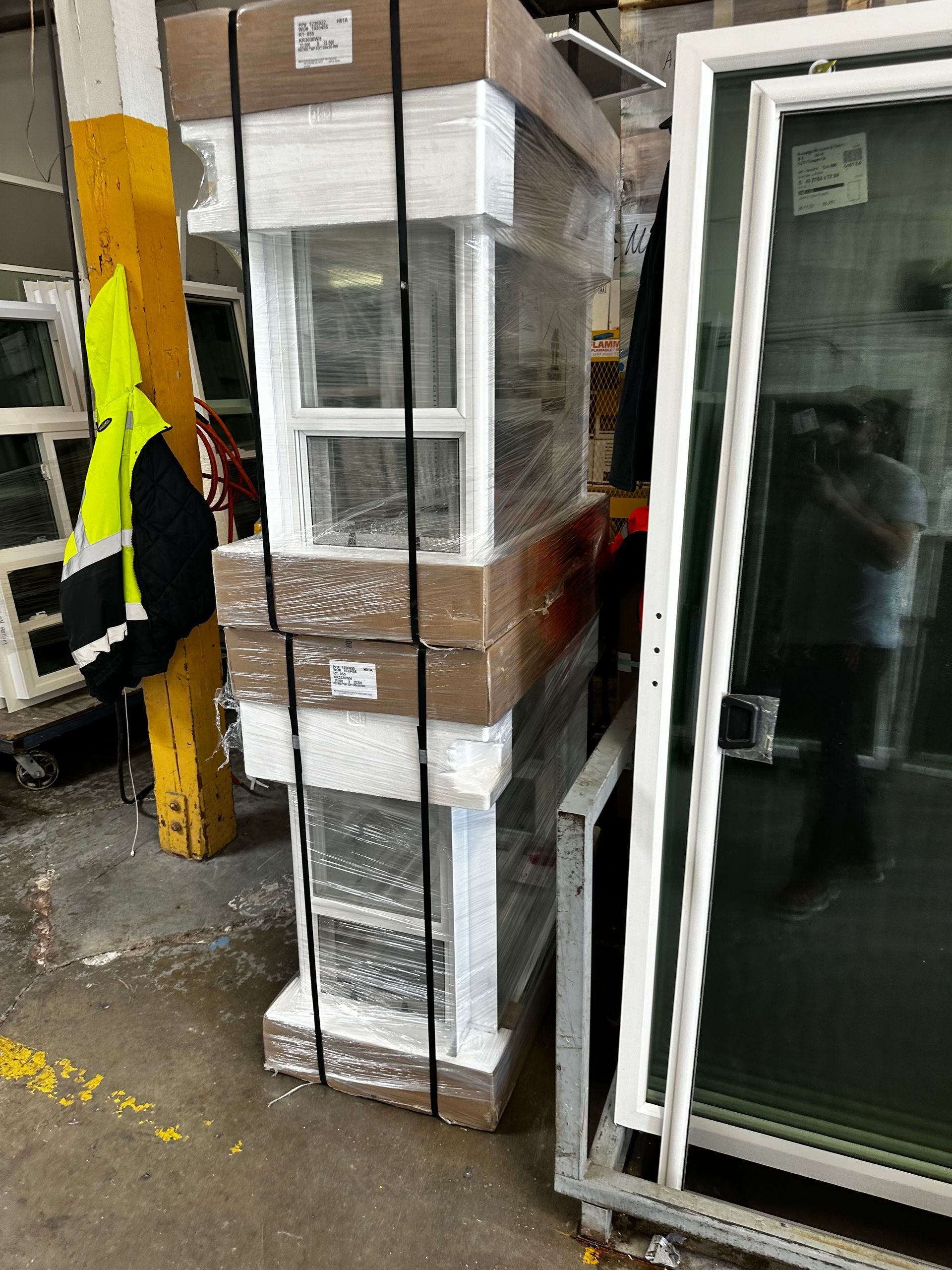 A bunch of boxes are stacked on top of each other in a warehouse.