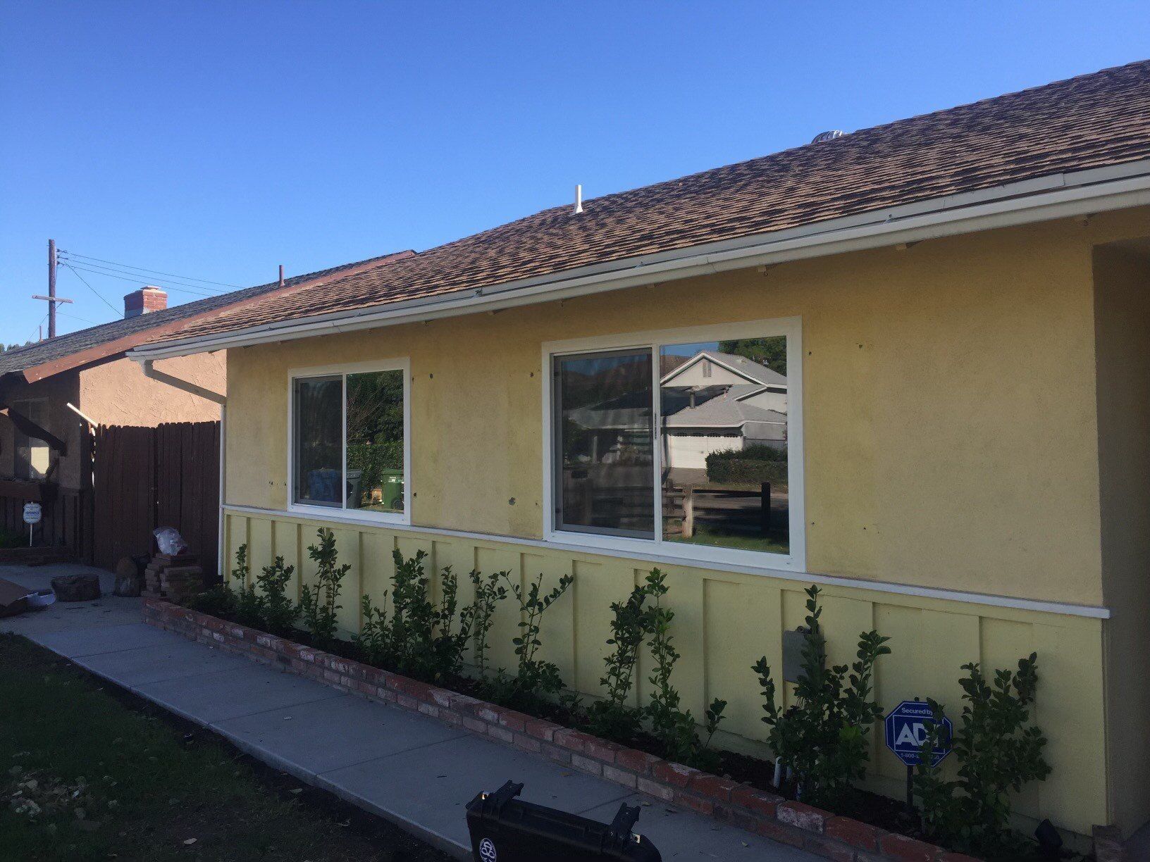 A house with a lot of windows and a walkway leading to it