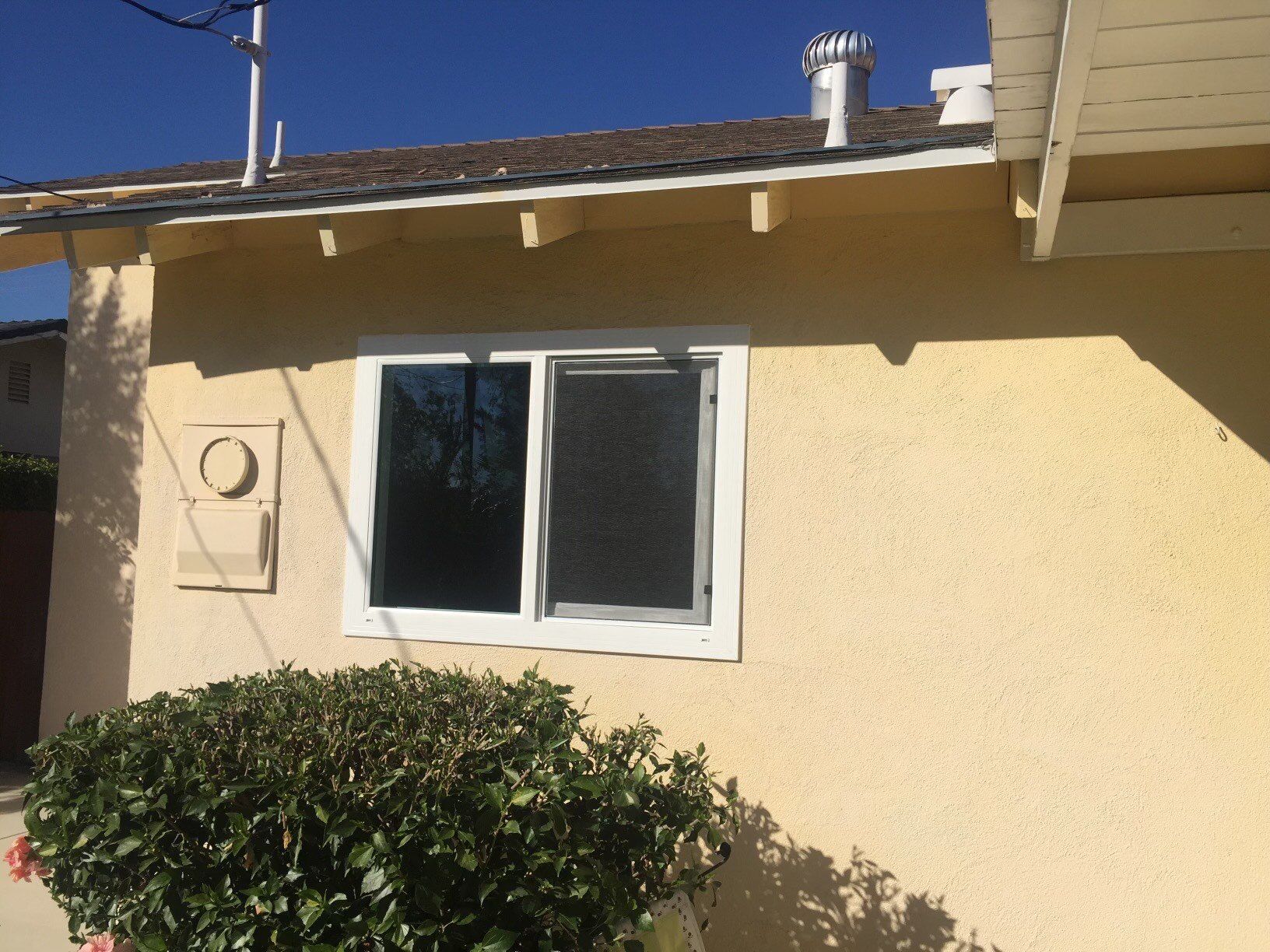 A house with a window and a chimney on the roof
